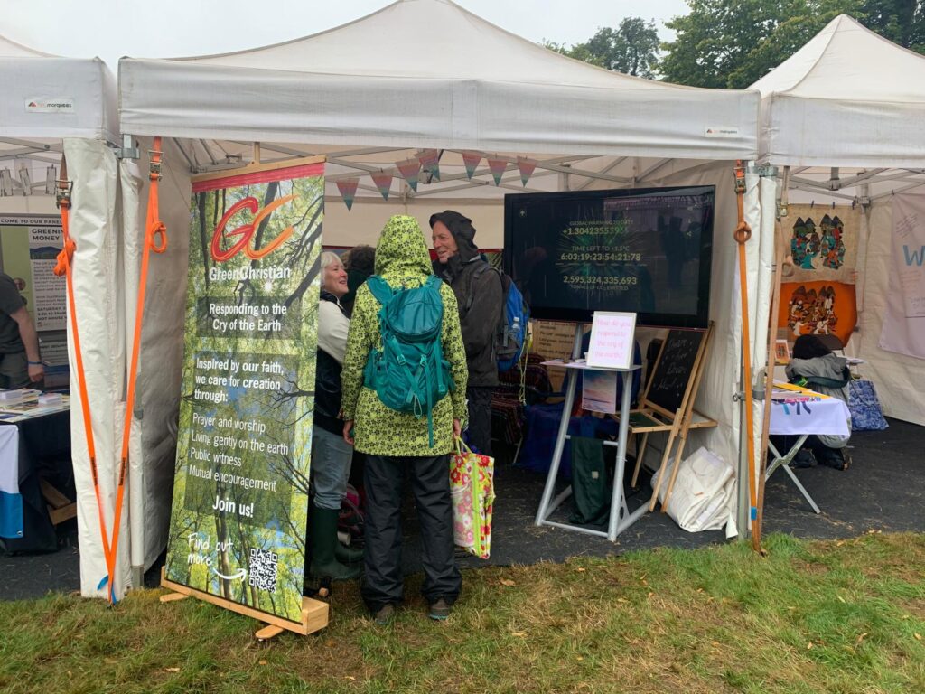 Whatever the weather, Green Christian's stall at Greenbelt is still gong